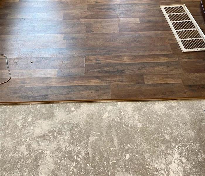 Dark wood flooring half removed from home