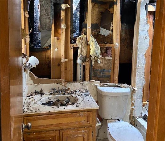 Bathroom Fire Damage With Missing Walls and Debris 